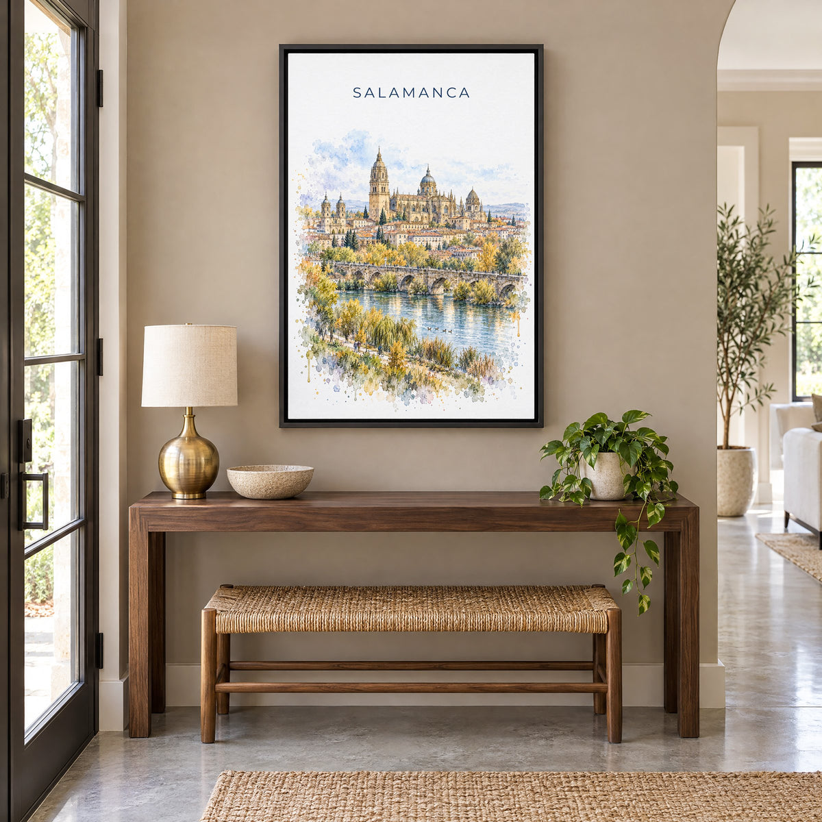 Salamanca watercolor print as a black floater canvas above a walnut console and woven bench in an entryway