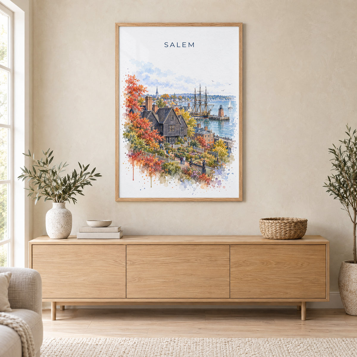 Salem, Massachusetts watercolor print in an oak frame above a light wood sideboard in a Scandinavian living room