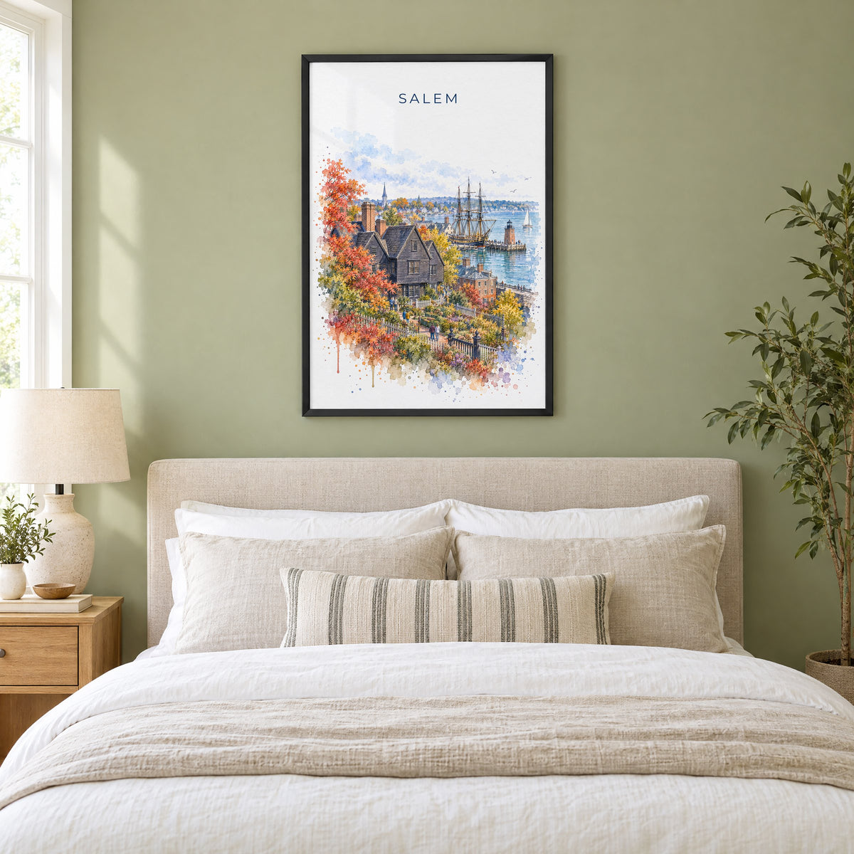 Salem, Massachusetts watercolor print in a black frame above an upholstered headboard in a sage green bedroom
