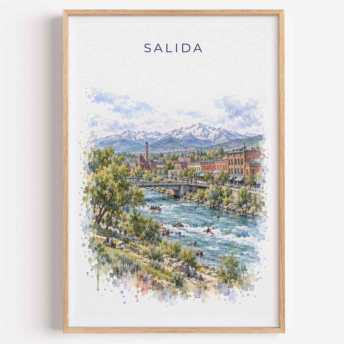 Salida, Colorado watercolor print in a light oak frame on a plain white wall
