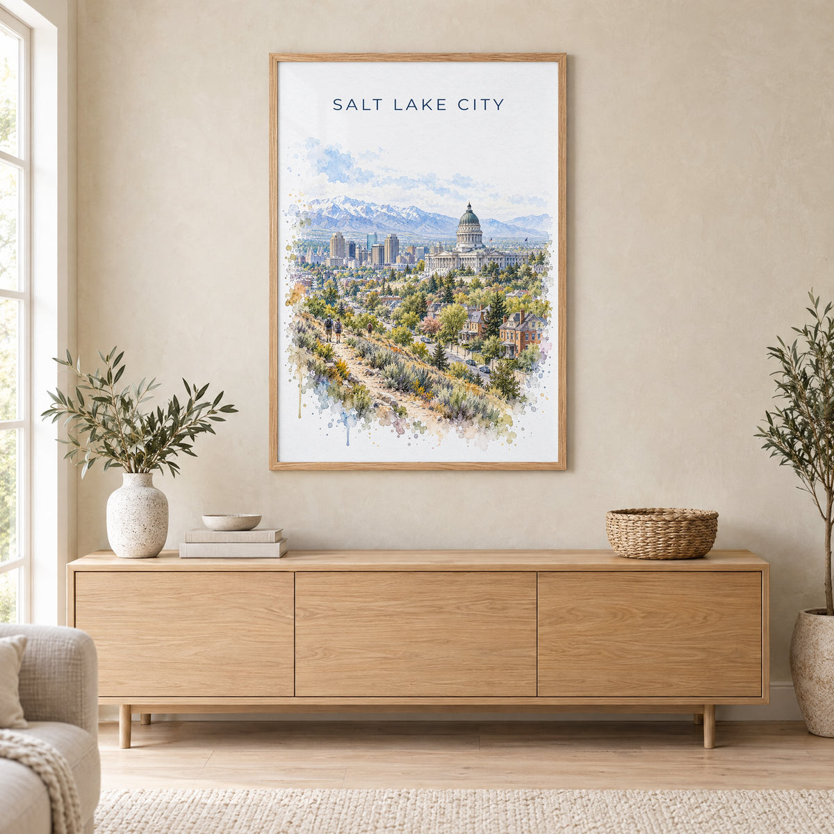 Salt Lake City watercolor print in an oak frame above a light wood sideboard in a Scandinavian living room
