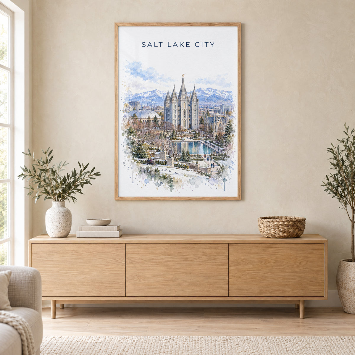 Salt Lake Temple watercolor print in an oak frame above a light wood sideboard in a Scandinavian living room