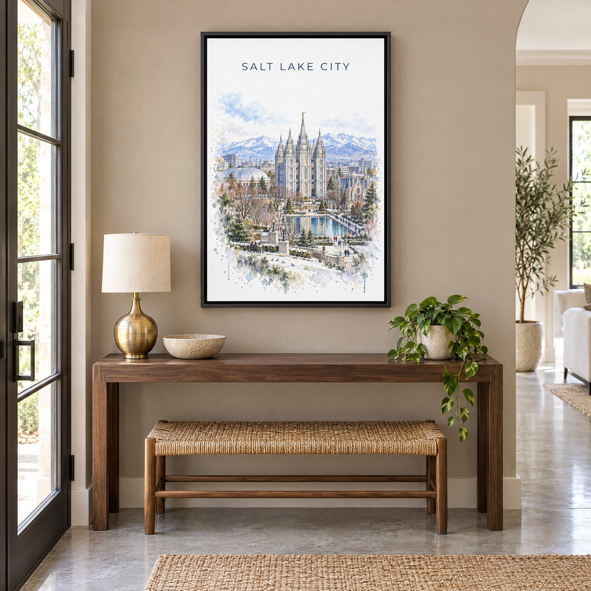 Salt Lake Temple watercolor print as a black floater canvas above a walnut console and woven bench in an entryway