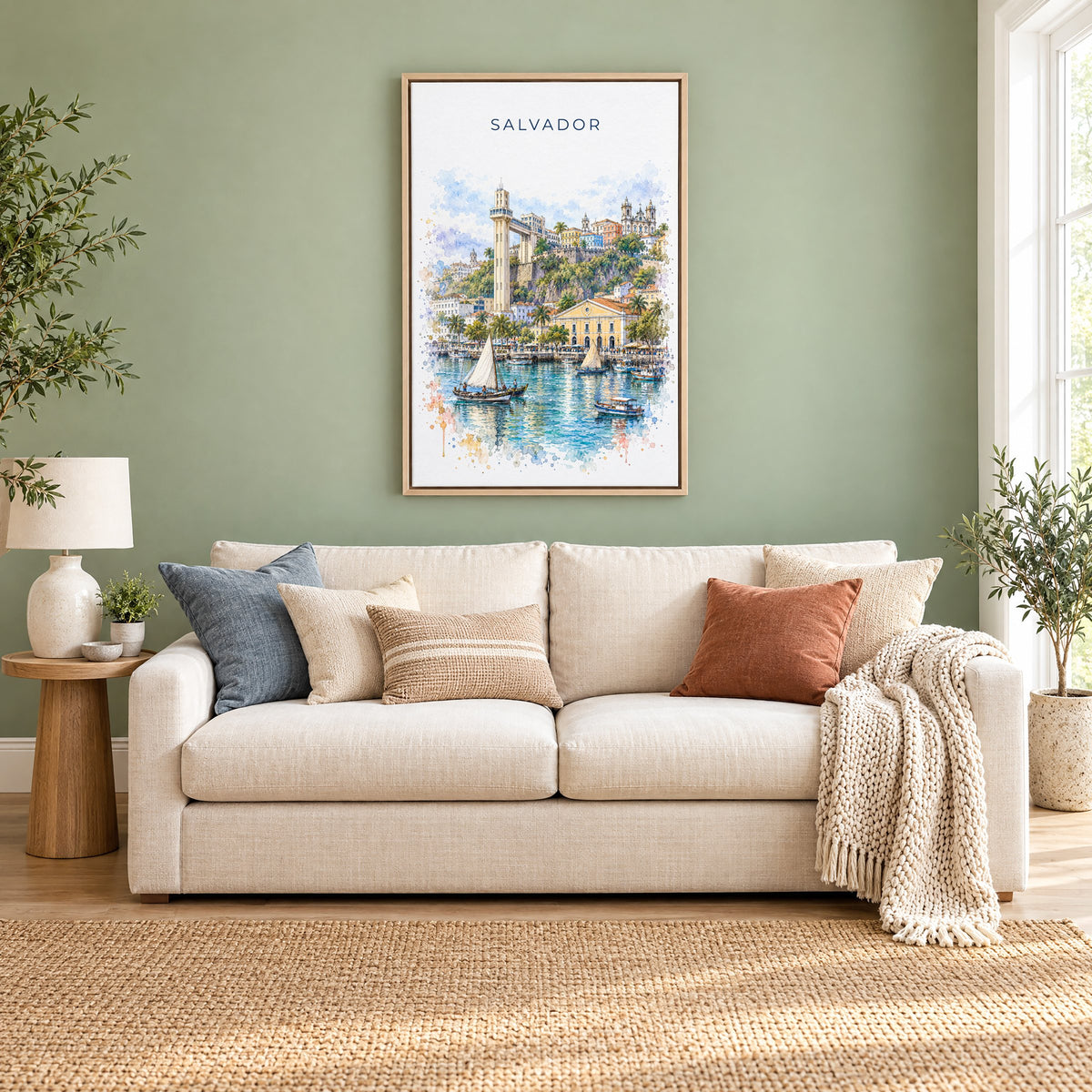 Salvador, Brazil watercolor print as a natural floater canvas above a cream linen sofa on a sage green wall