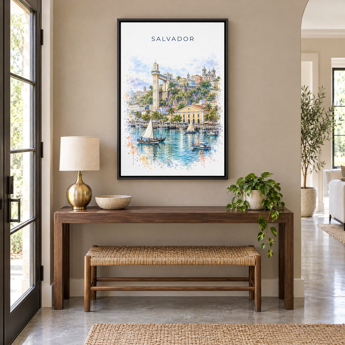 Salvador, Brazil watercolor print as a black floater canvas above a walnut console and woven bench in an entryway