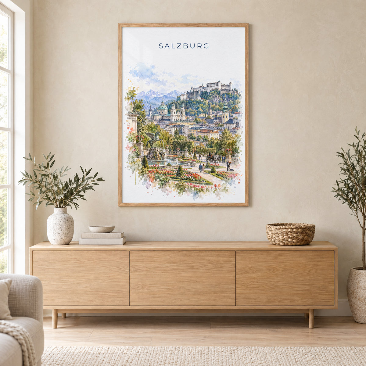Salzburg watercolor print in an oak frame above a light wood sideboard in a Scandinavian living room