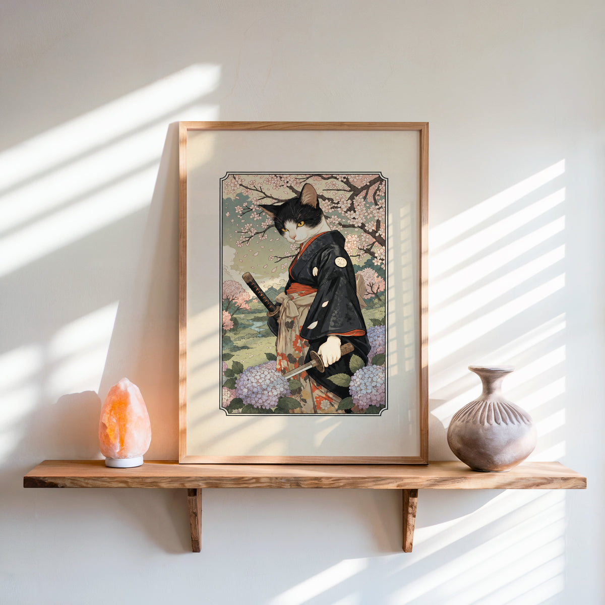 samurai cat with katana print in an oak frame on a live-edge wall shelf with a salt lamp and clay vase