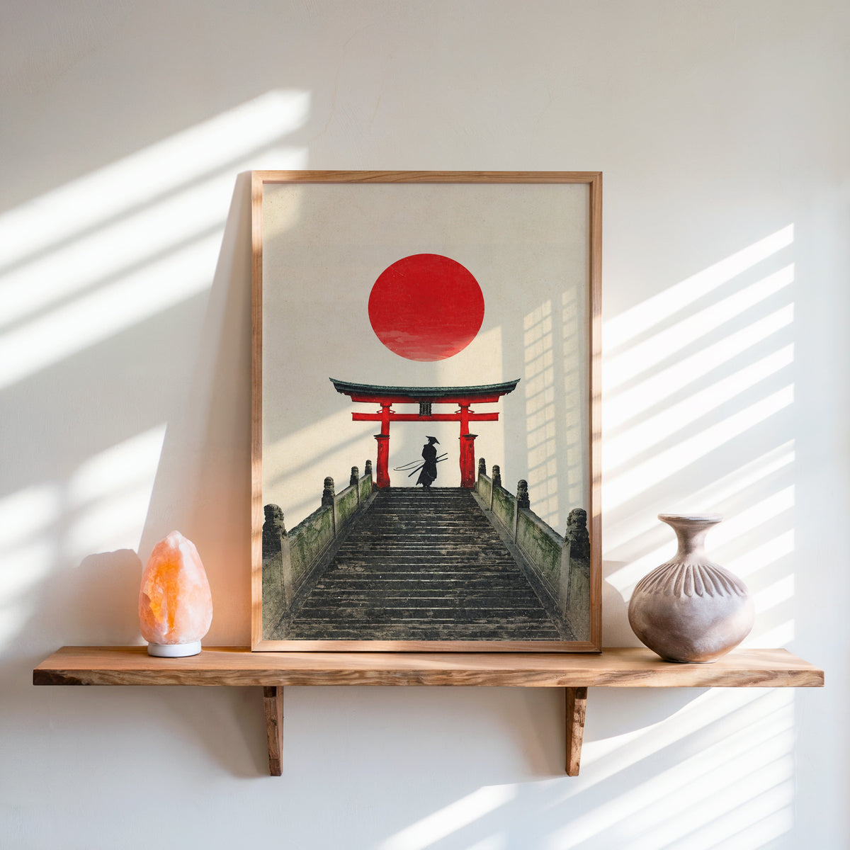 samurai under red torii gate print in an oak frame on a live-edge wall shelf with a salt lamp and clay vase