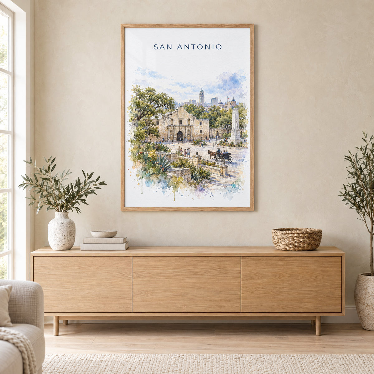 San Antonio watercolor print in an oak frame above a light wood sideboard in a Scandinavian living room