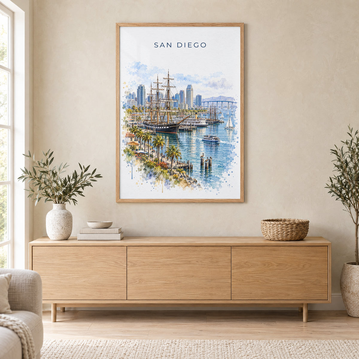 San Diego Bay watercolor print in an oak frame above a light wood sideboard in a Scandinavian living room