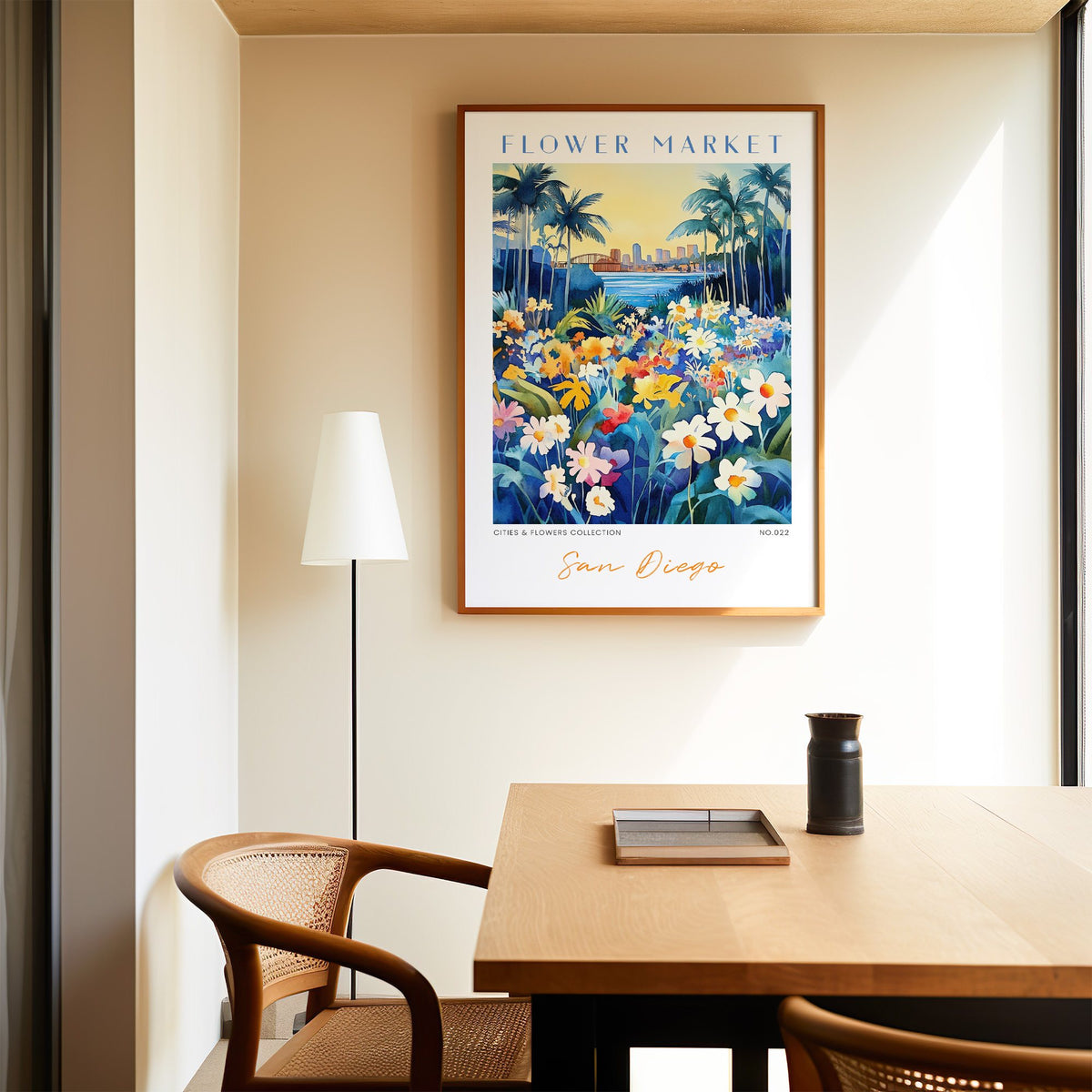 San Diego flower market print in an oak frame above a dining table and cane chair