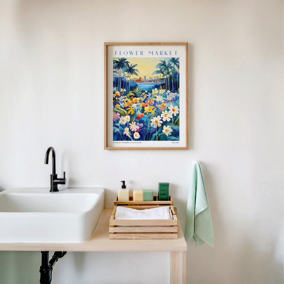 San Diego flower market print in an oak frame above a white bathroom sink with folded towels