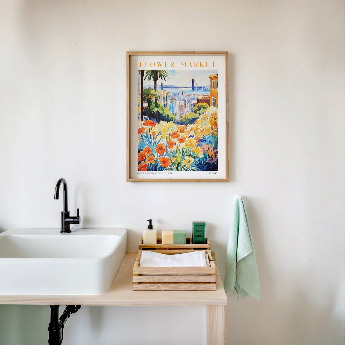 San Francisco flower market print in an oak frame above a white bathroom sink with folded towels