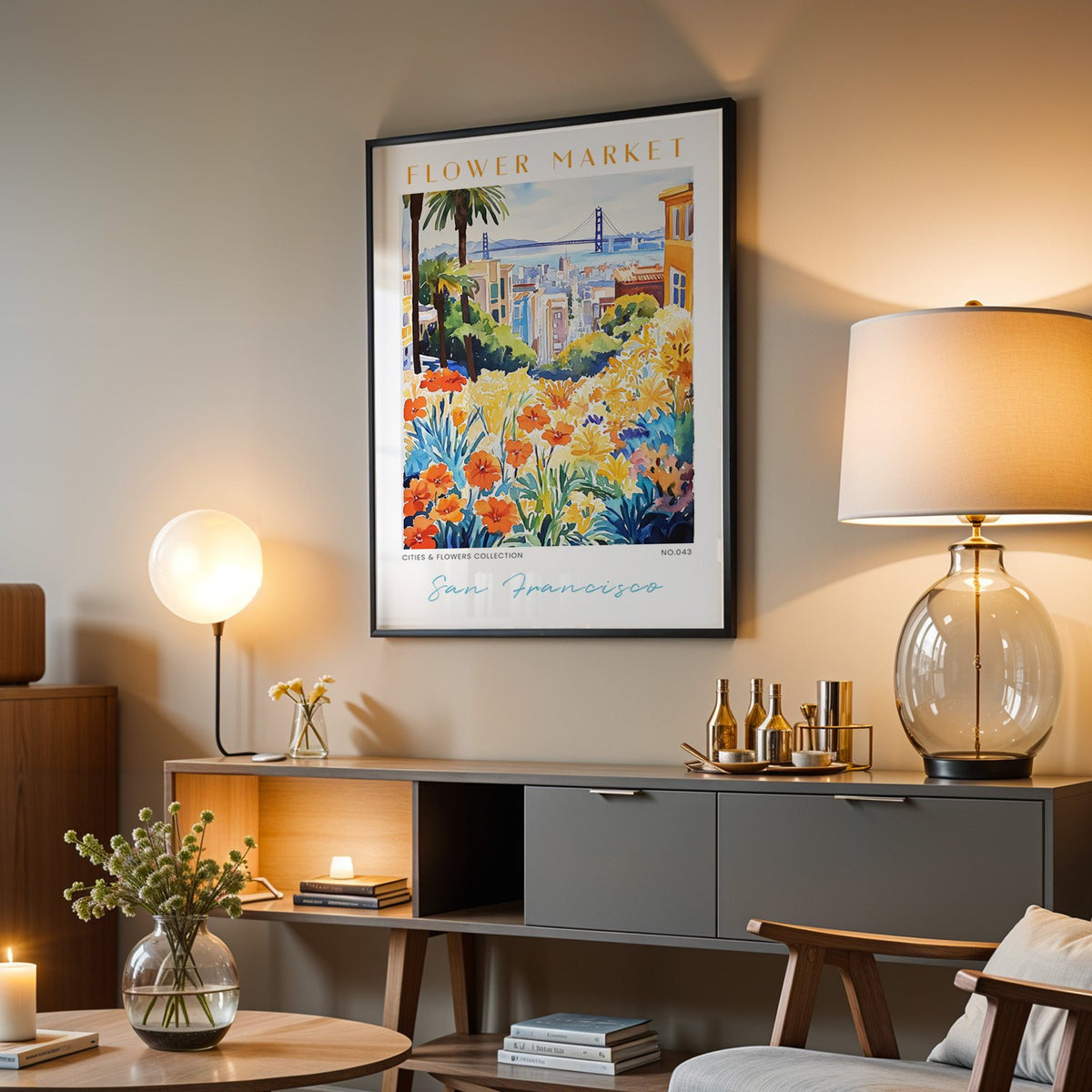 San Francisco flower market print in a black frame above a grey media console with a glass table lamp