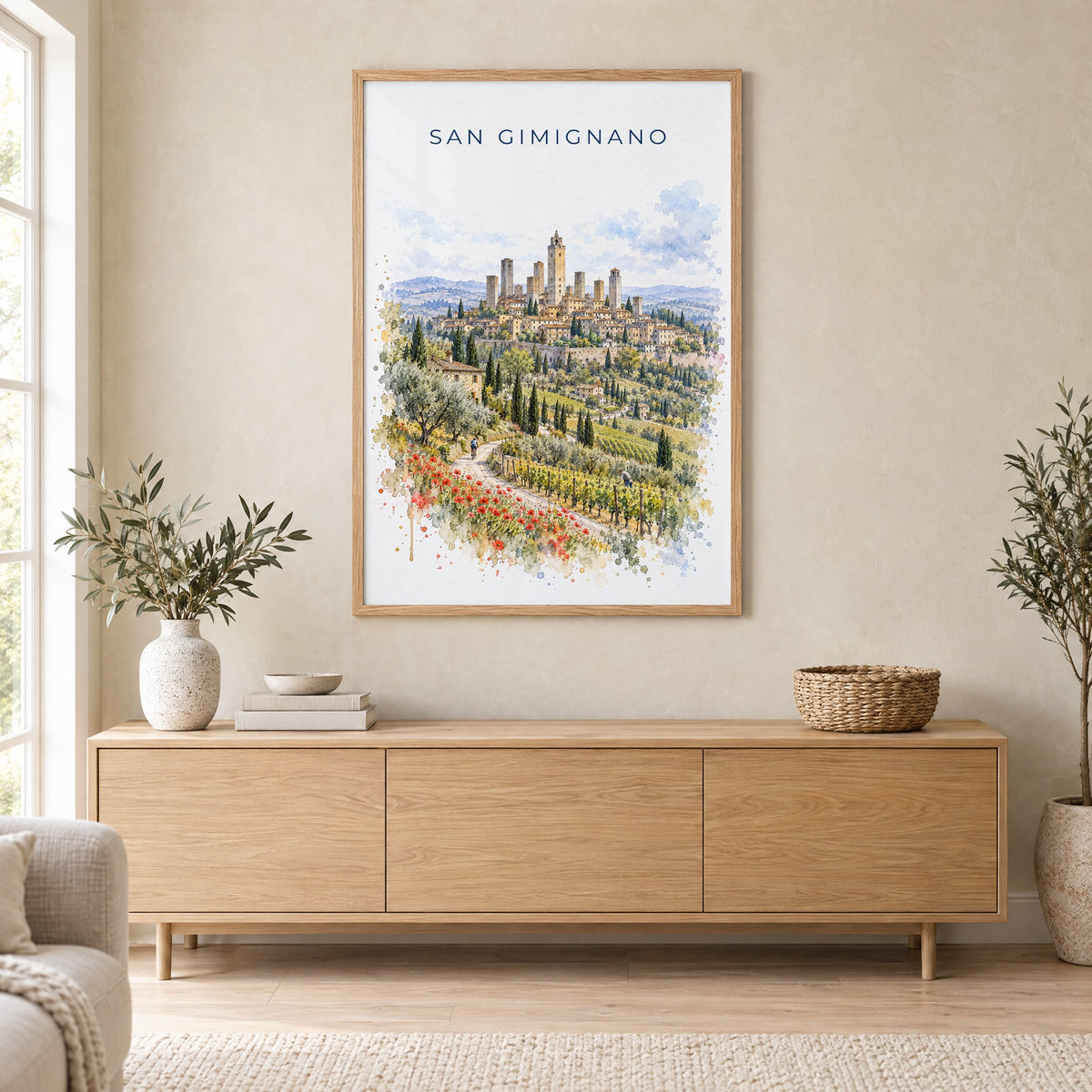 San Gimignano watercolor print in an oak frame above a light wood sideboard in a Scandinavian living room
