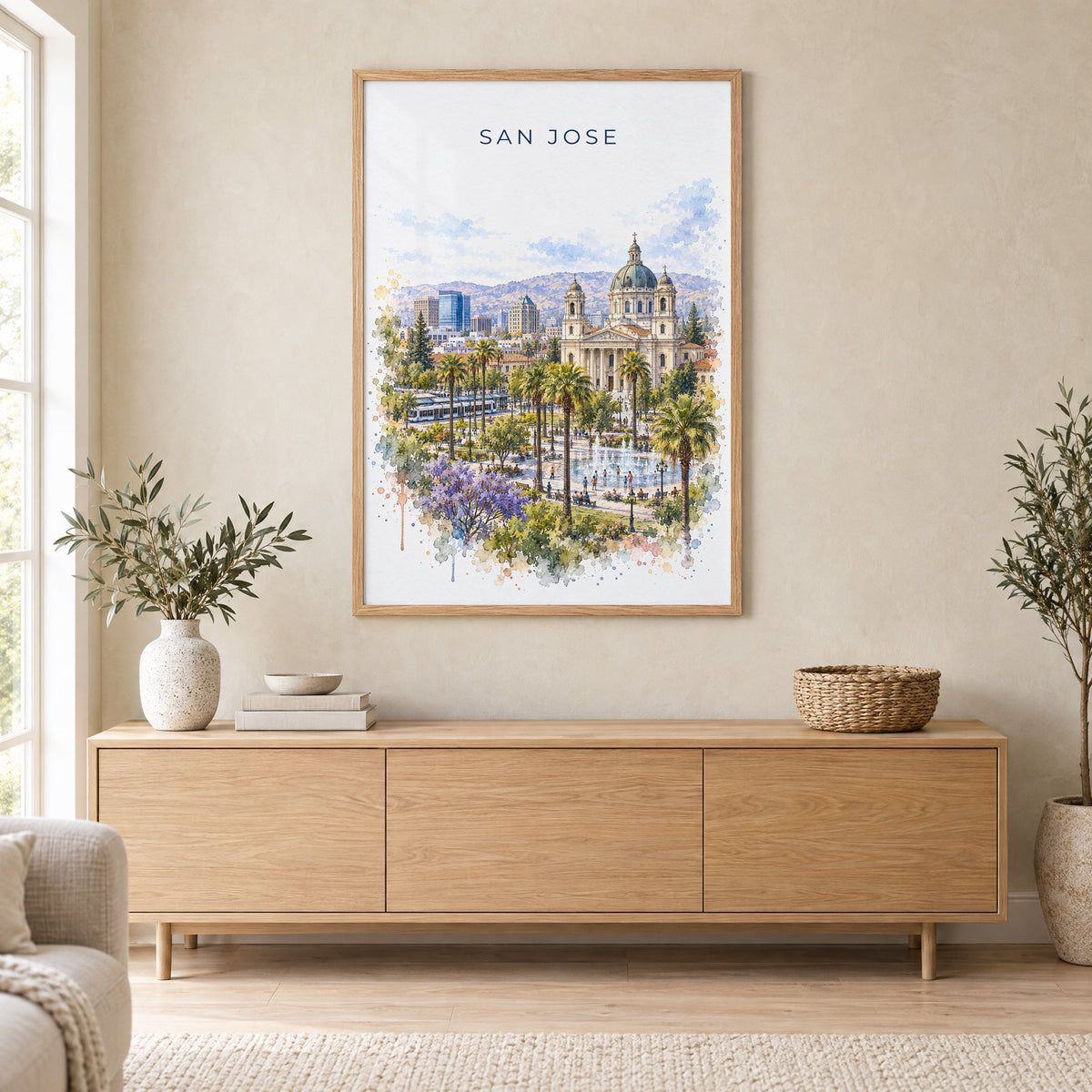 San Jose, California watercolor print in an oak frame above a light wood sideboard in a Scandinavian living room