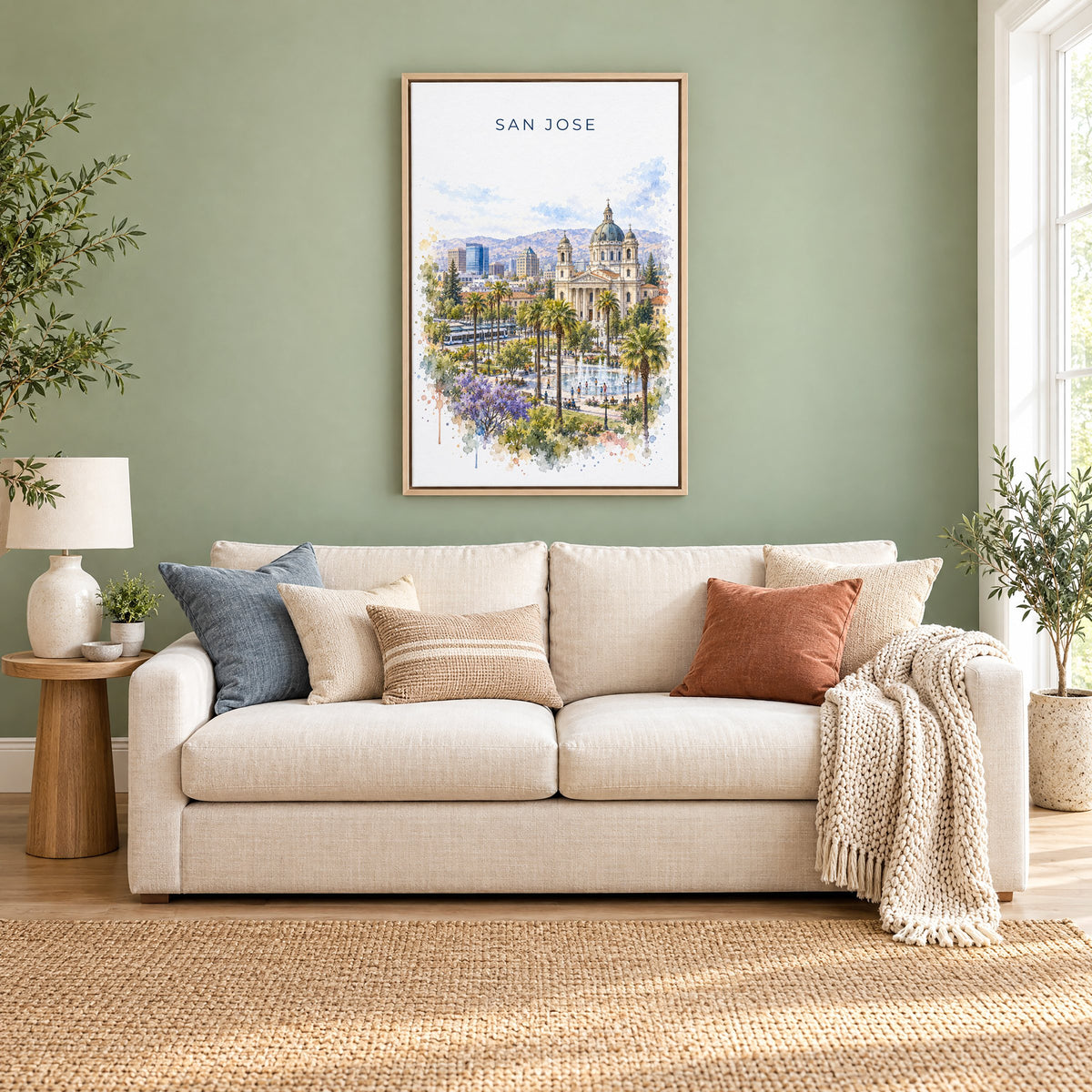 San Jose, California watercolor print as a natural floater canvas above a cream linen sofa on a sage green wall