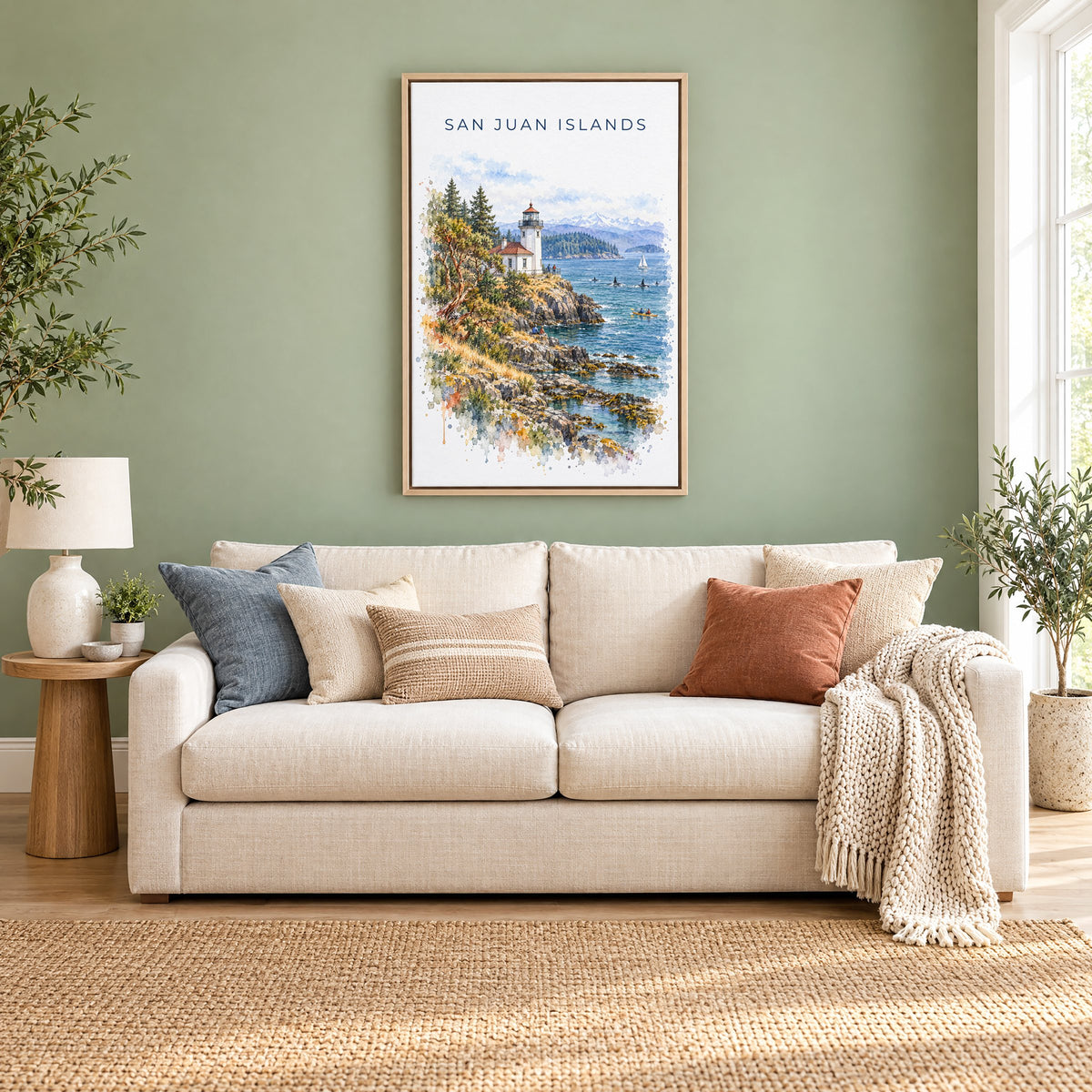San Juan Islands watercolor print as a natural floater canvas above a cream linen sofa on a sage green wall