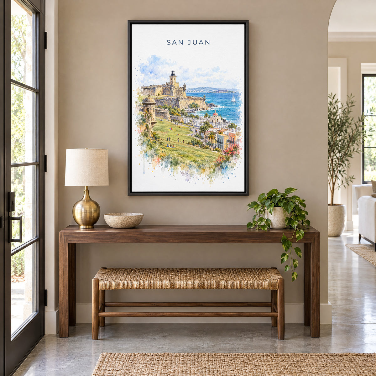 San Juan watercolor print as a black floater canvas above a walnut console and woven bench in an entryway