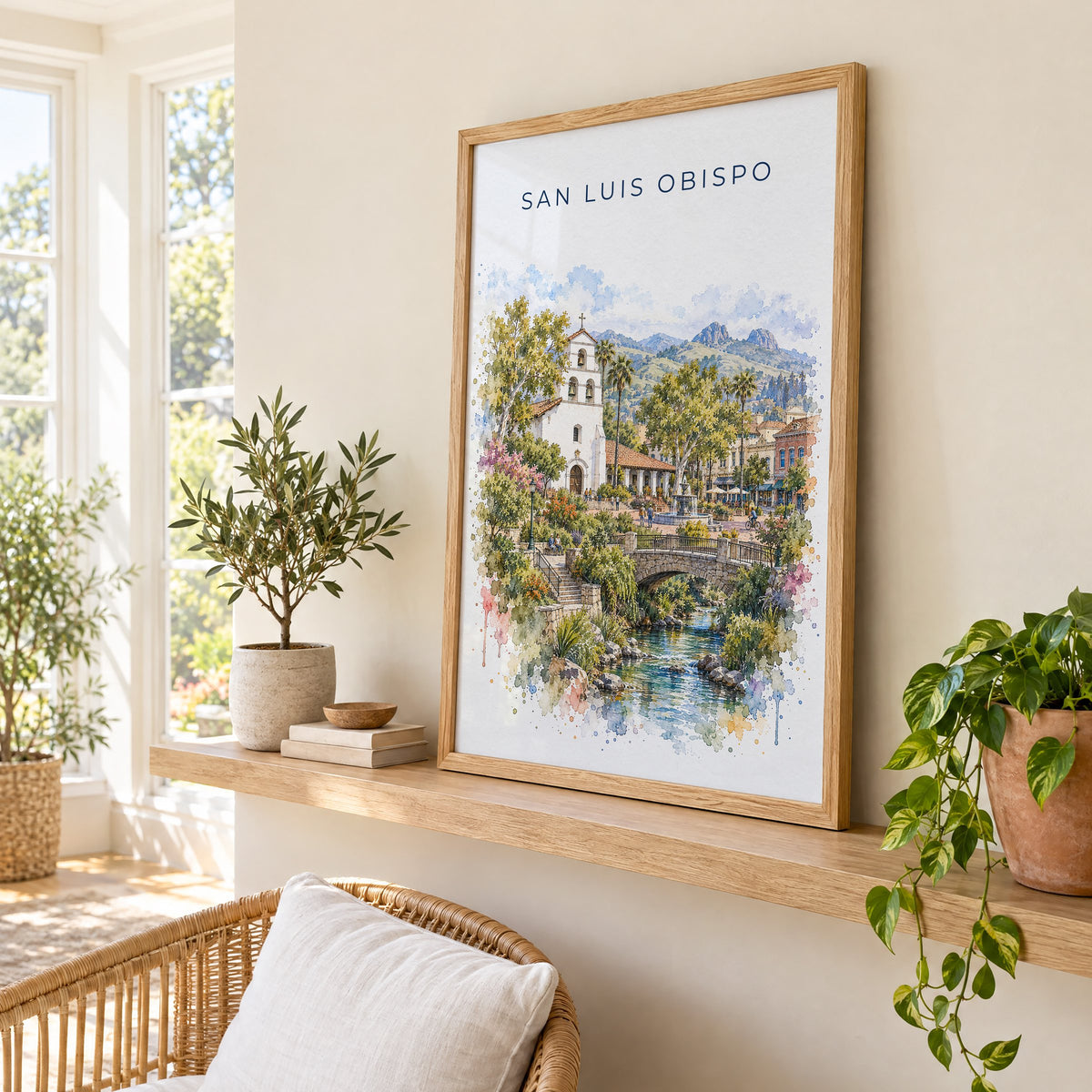 San Luis Obispo watercolor print in an oak frame on a picture ledge in a sunlit sunroom