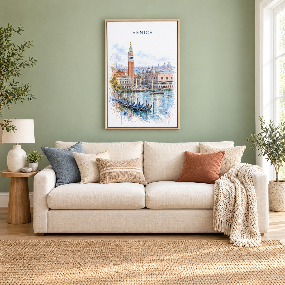 St. Mark's Square Venice watercolor print as a natural floater canvas above a cream linen sofa on a sage green wall