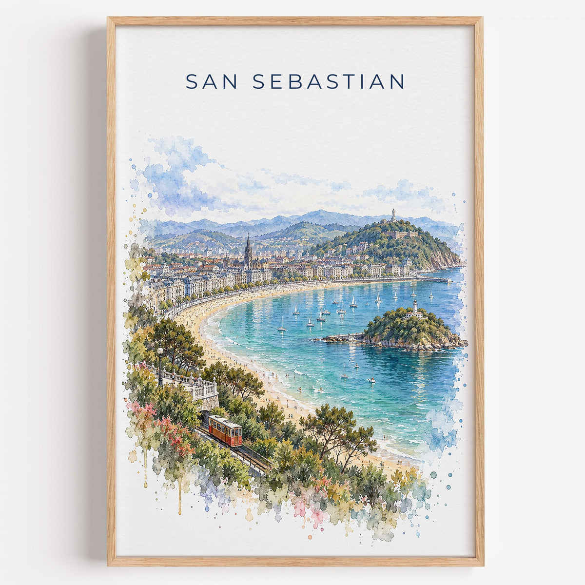 San Sebastian watercolor print in a light oak frame on a plain white wall
