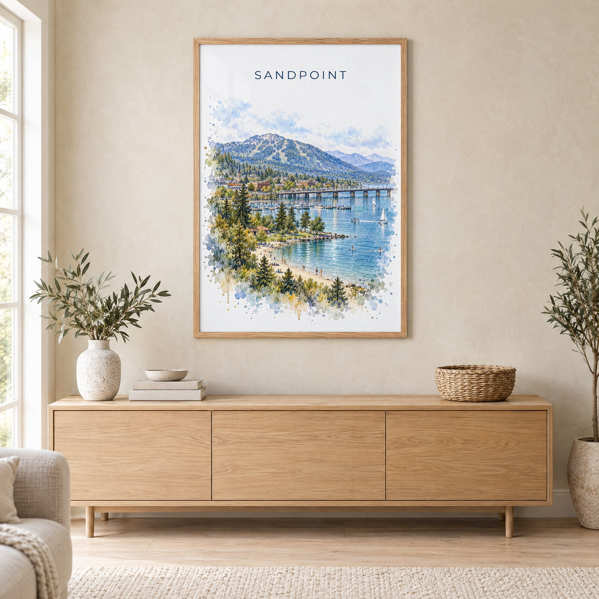 Sandpoint watercolor print in an oak frame above a light wood sideboard in a Scandinavian living room