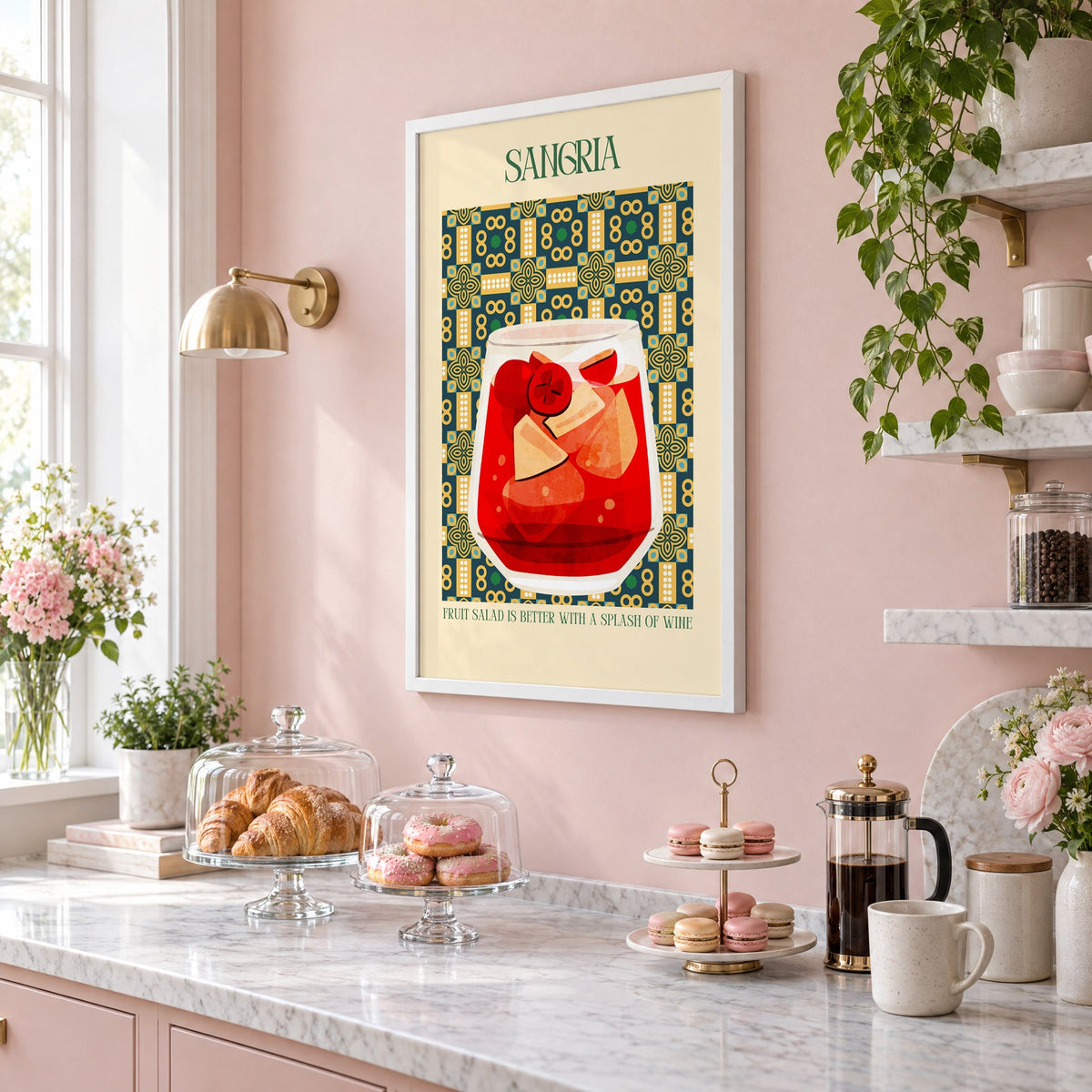 SANGRIA red glass patterned tile print in a white frame on a blush pink wall above a patisserie counter with croissants and macarons, seen at an angle