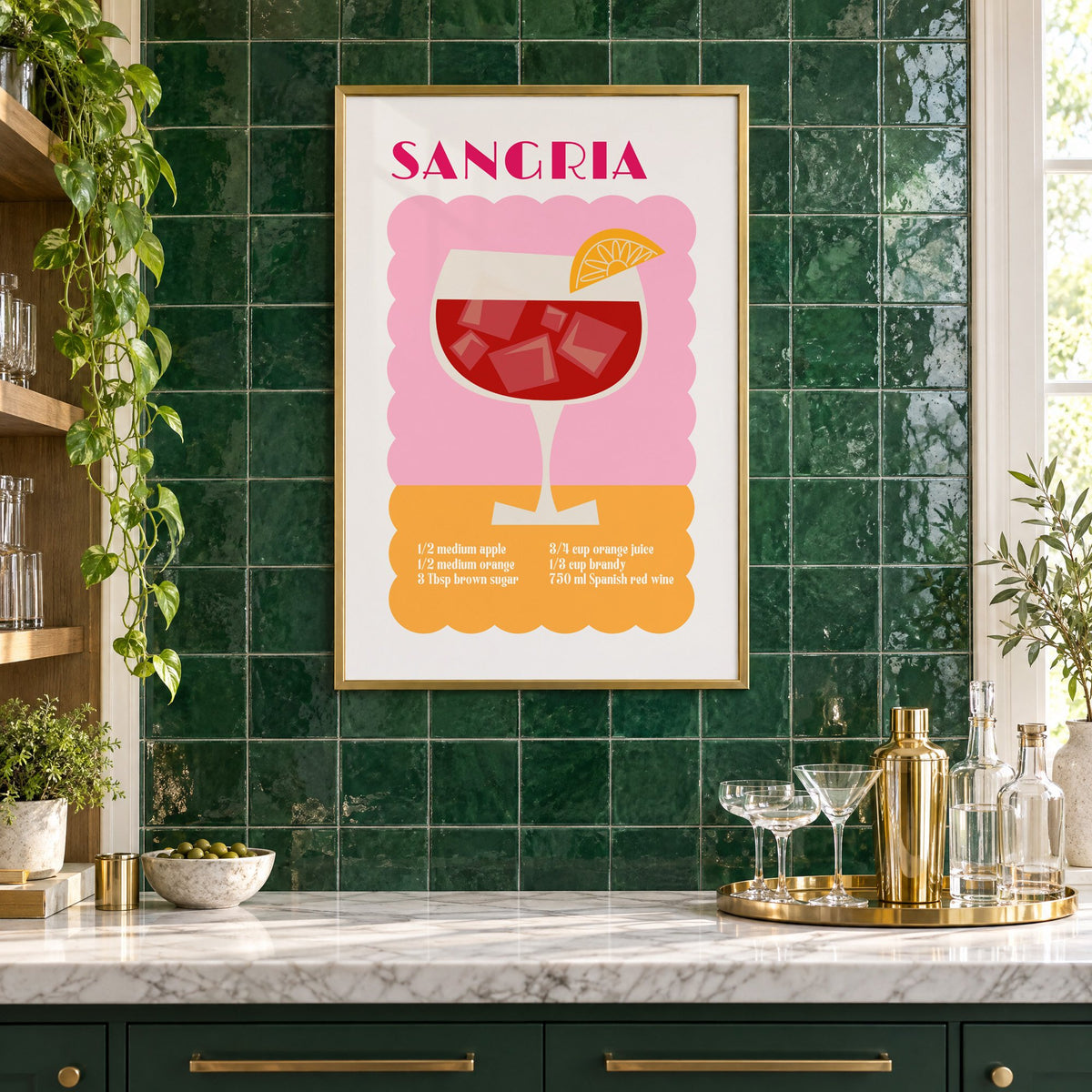 SANGRIA recipe pink and orange print in a brass frame on emerald green tiles above a home bar with coupe glasses