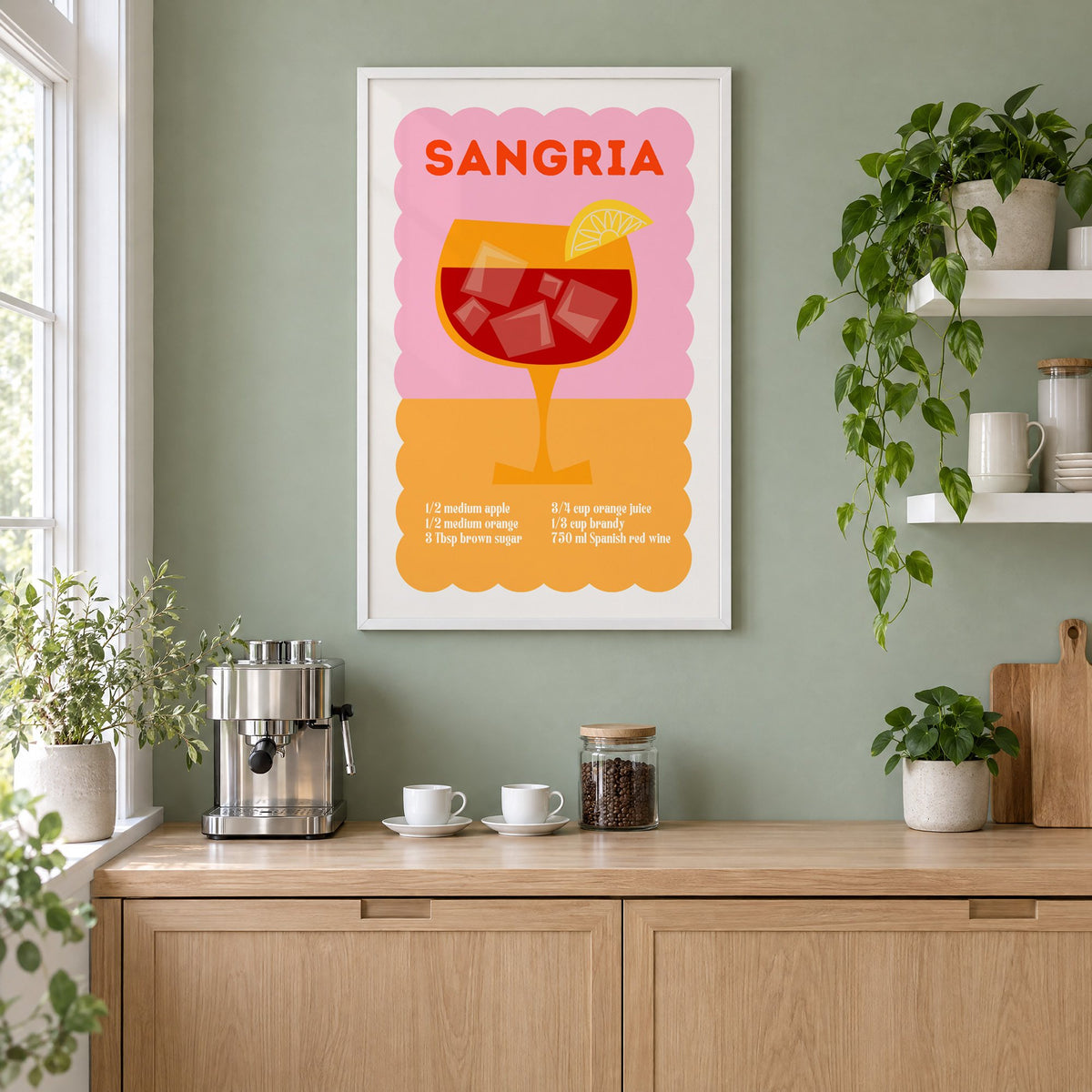Sangria recipe pink and orange print in a white frame on a sage green coffee nook wall above an espresso machine