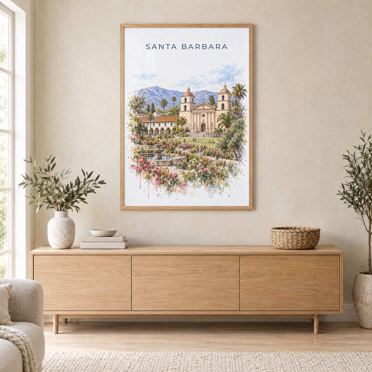 Santa Barbara watercolor print in an oak frame above a light wood sideboard in a Scandinavian living room