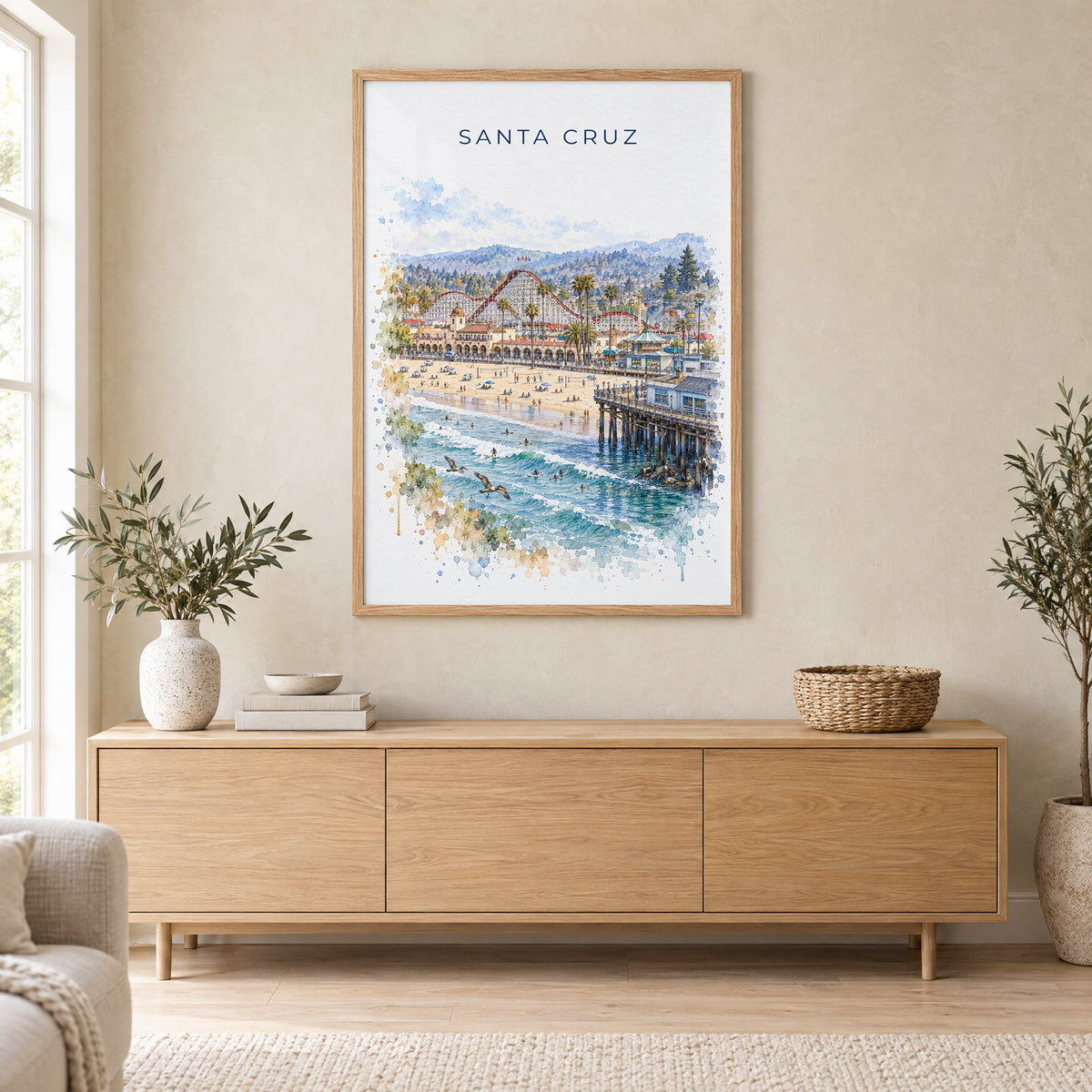 Santa Cruz, California watercolor print in an oak frame above a light wood sideboard in a Scandinavian living room