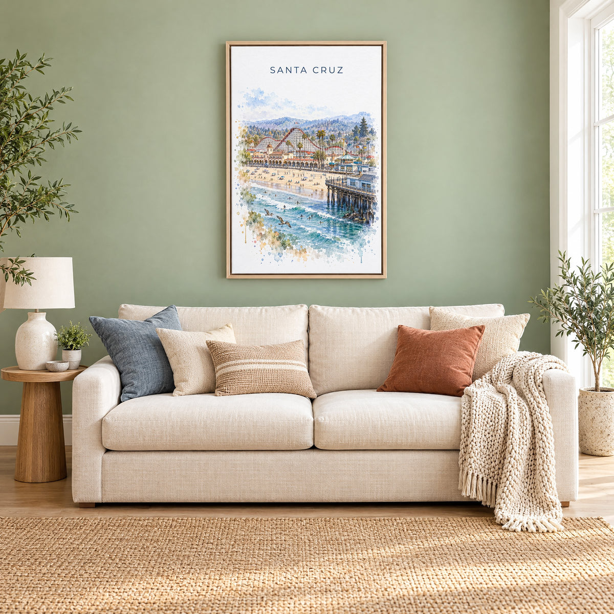 Santa Cruz, California watercolor print as a natural floater canvas above a cream linen sofa on a sage green wall