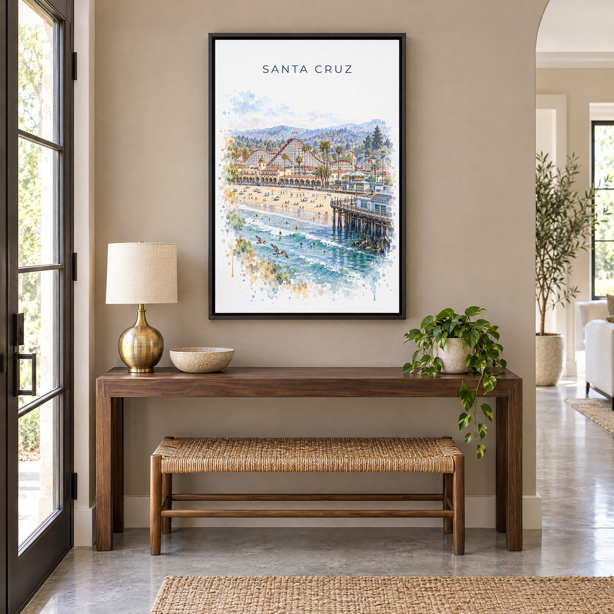 Santa Cruz, California watercolor print as a black floater canvas above a walnut console and woven bench in an entryway