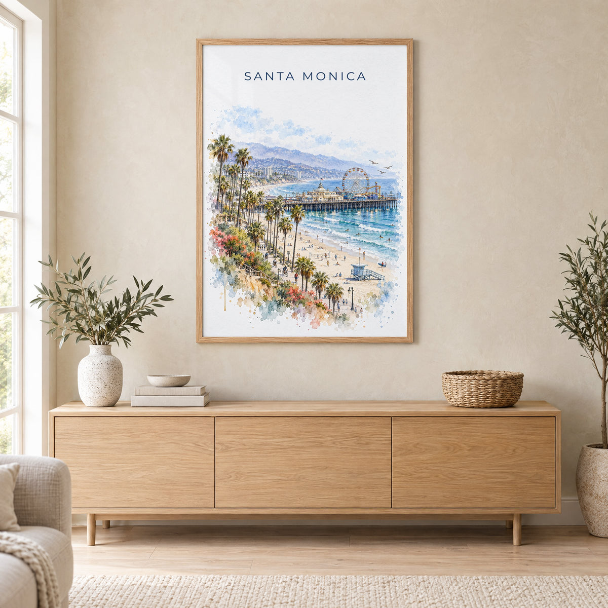 Santa Monica watercolor print in an oak frame above a light wood sideboard in a Scandinavian living room