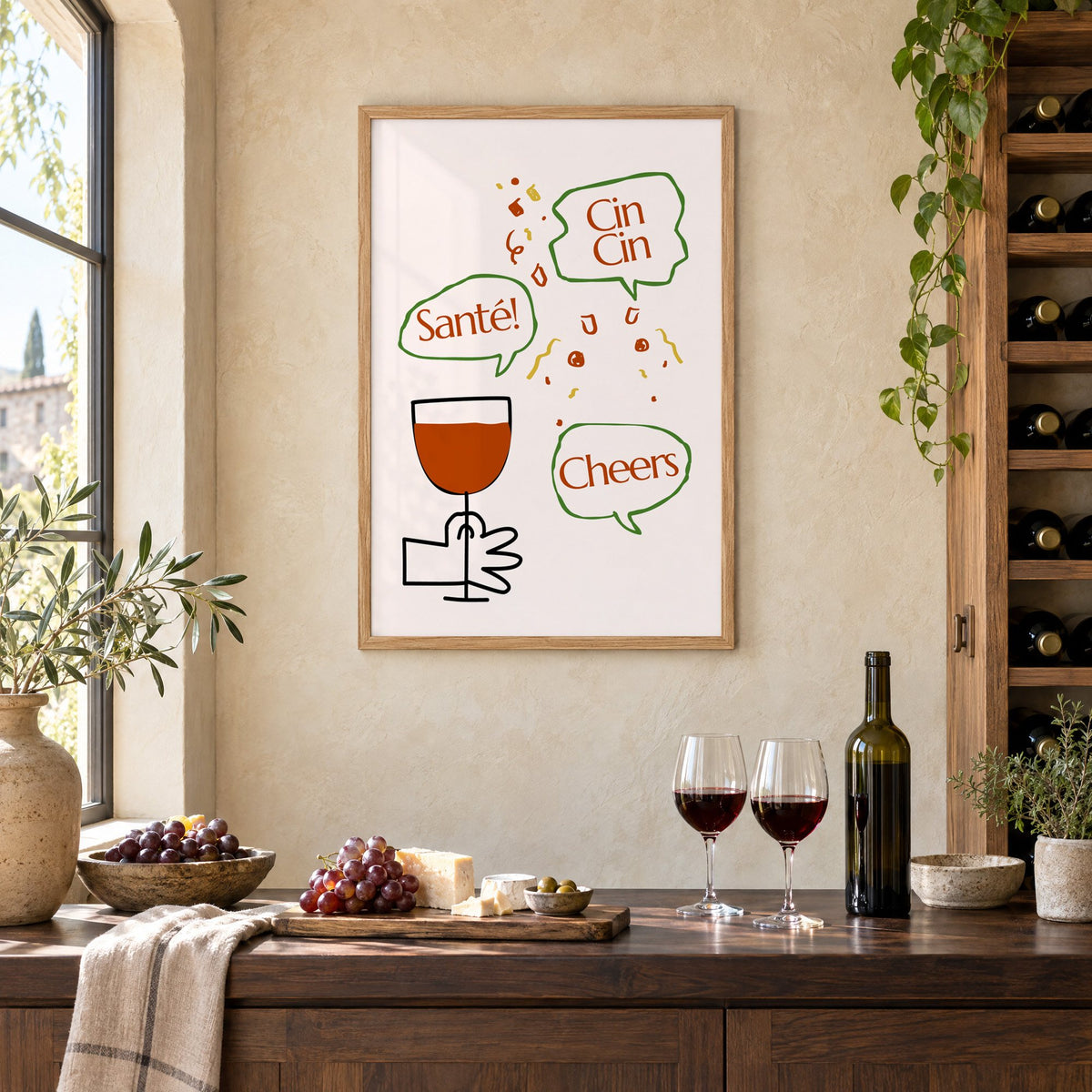 Cin Cin Santé Cheers speech bubbles wine print in an oak frame on a limewashed wall above a wine counter with red wine, cheese and grapes