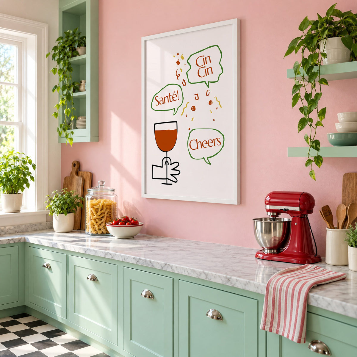 Cin Cin Santé Cheers speech bubbles wine print in a white frame on a pink wall above mint green cabinets in a retro kitchen, seen at an angle