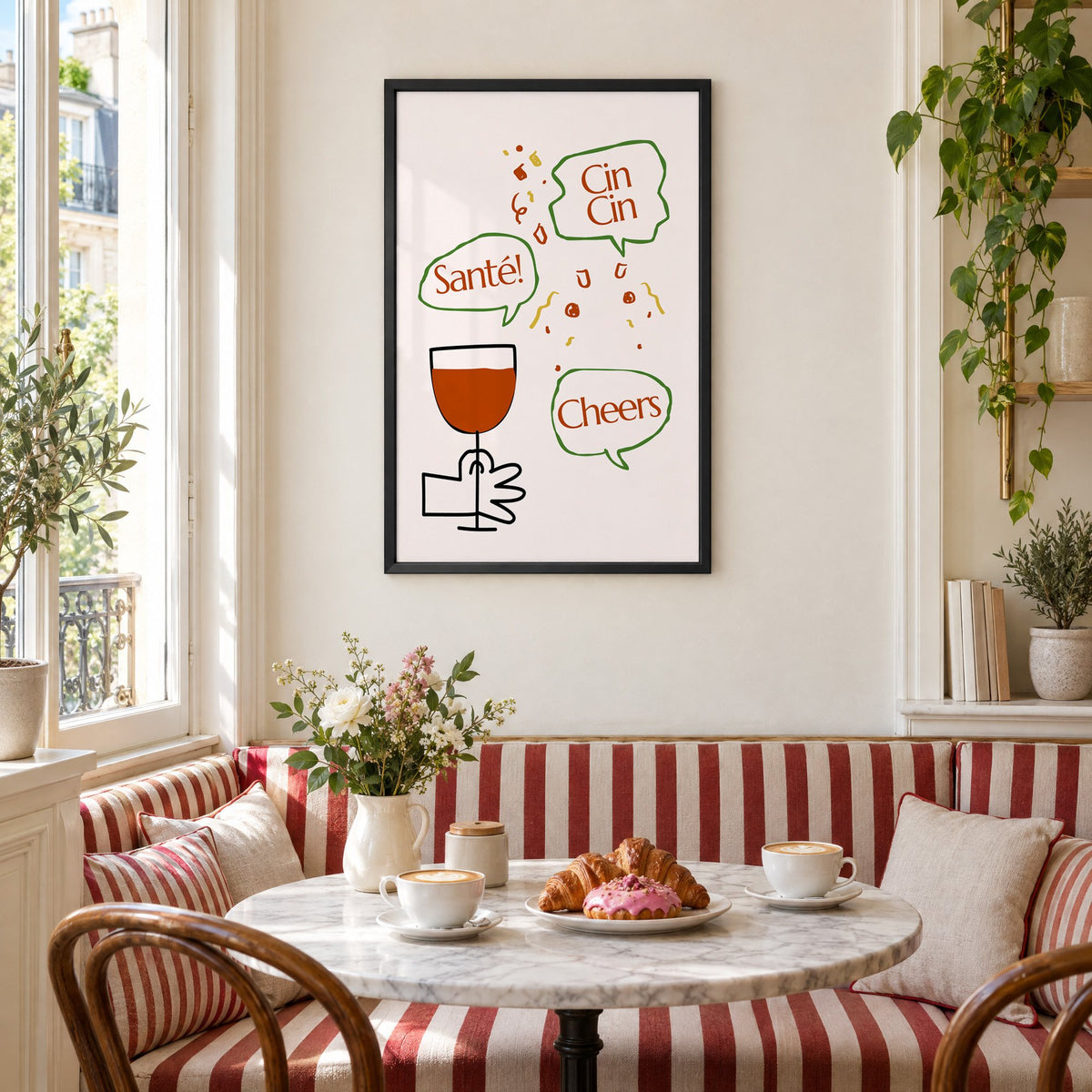 Cin Cin Santé Cheers speech bubbles wine print in a black frame above a striped cafe breakfast nook with cappuccino and pastries