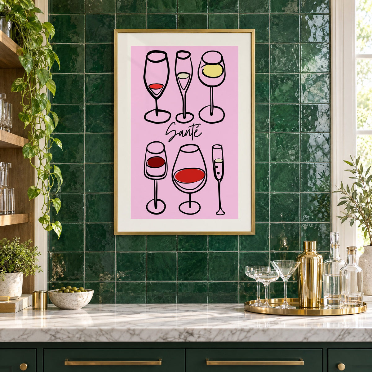 Santé wine glasses line art print in a brass frame on emerald green tiles above a home bar with coupe glasses
