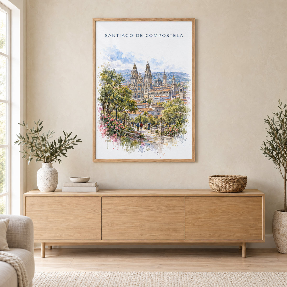 Santiago de Compostela watercolor print in an oak frame above a light wood sideboard in a Scandinavian living room