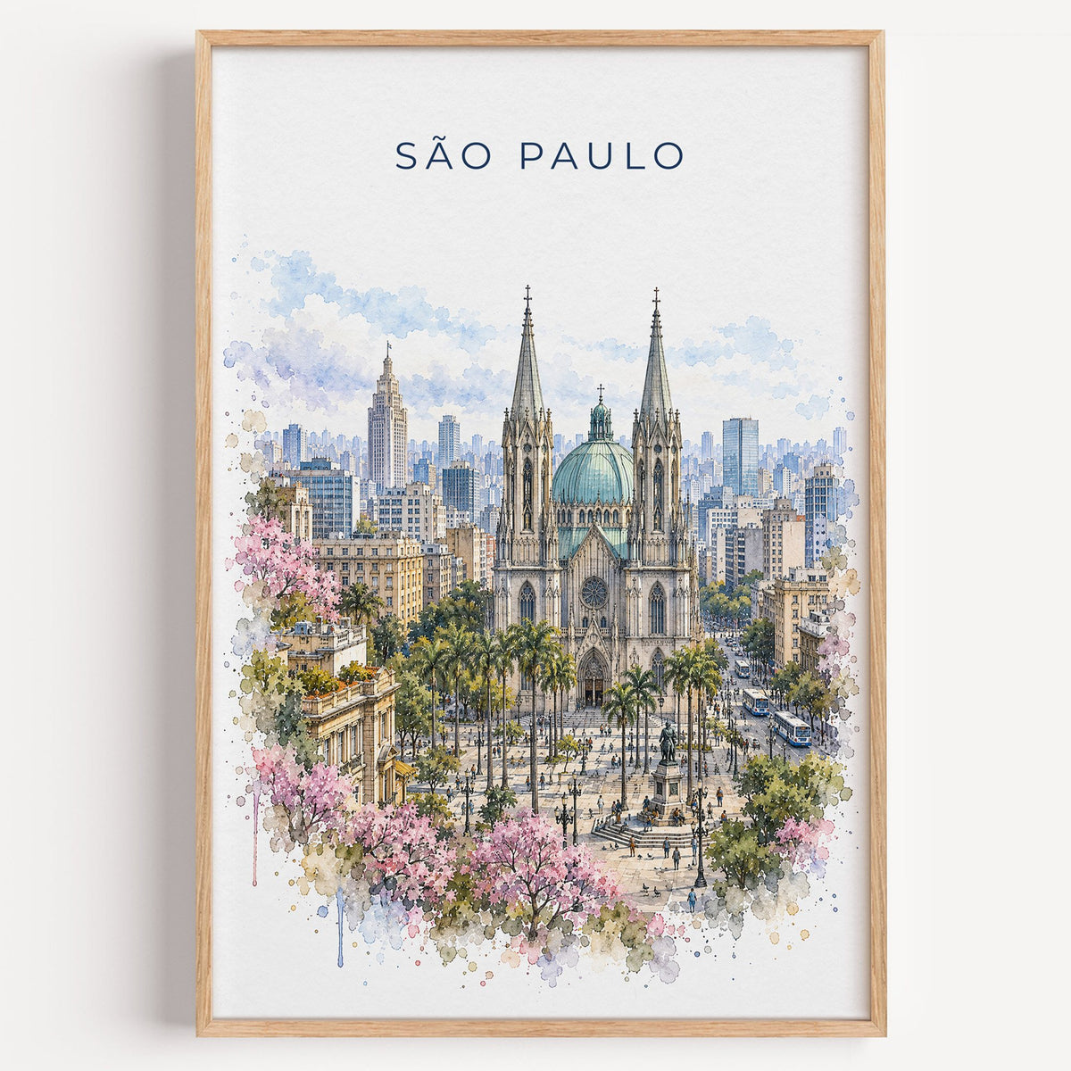 São Paulo watercolor print in a light oak frame on a plain white wall