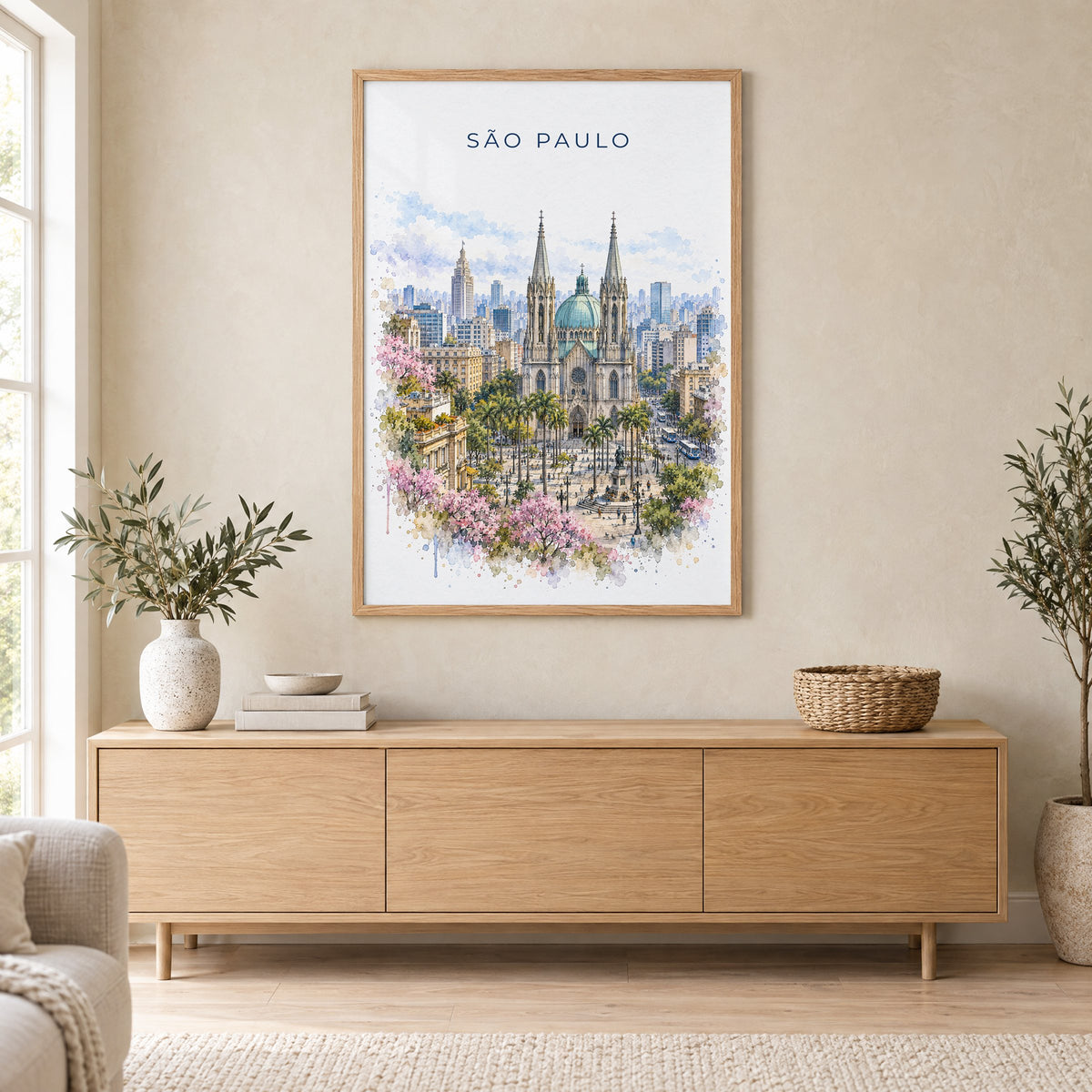 São Paulo watercolor print in an oak frame above a light wood sideboard in a Scandinavian living room