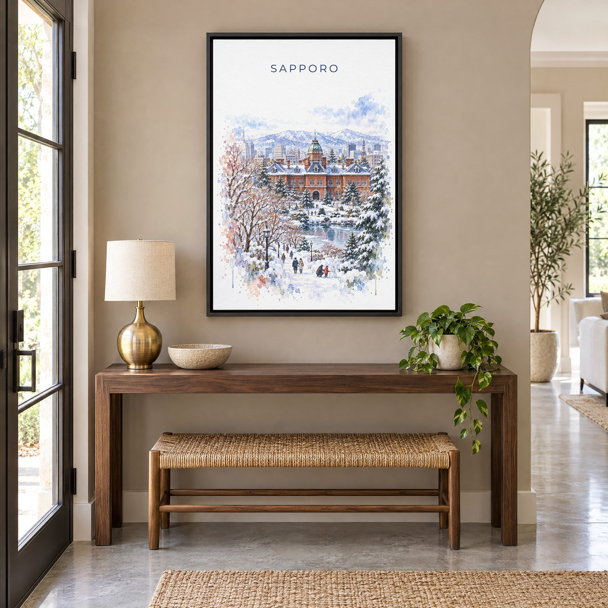 Sapporo watercolor print as a black floater canvas above a walnut console and woven bench in an entryway