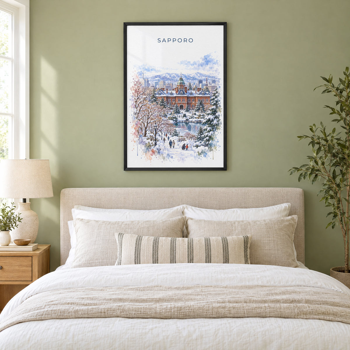Sapporo watercolor print in a black frame above an upholstered headboard in a sage green bedroom