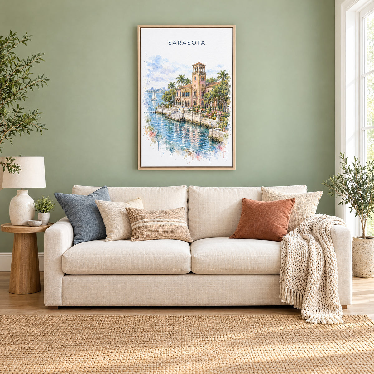 Sarasota watercolor print as a natural floater canvas above a cream linen sofa on a sage green wall
