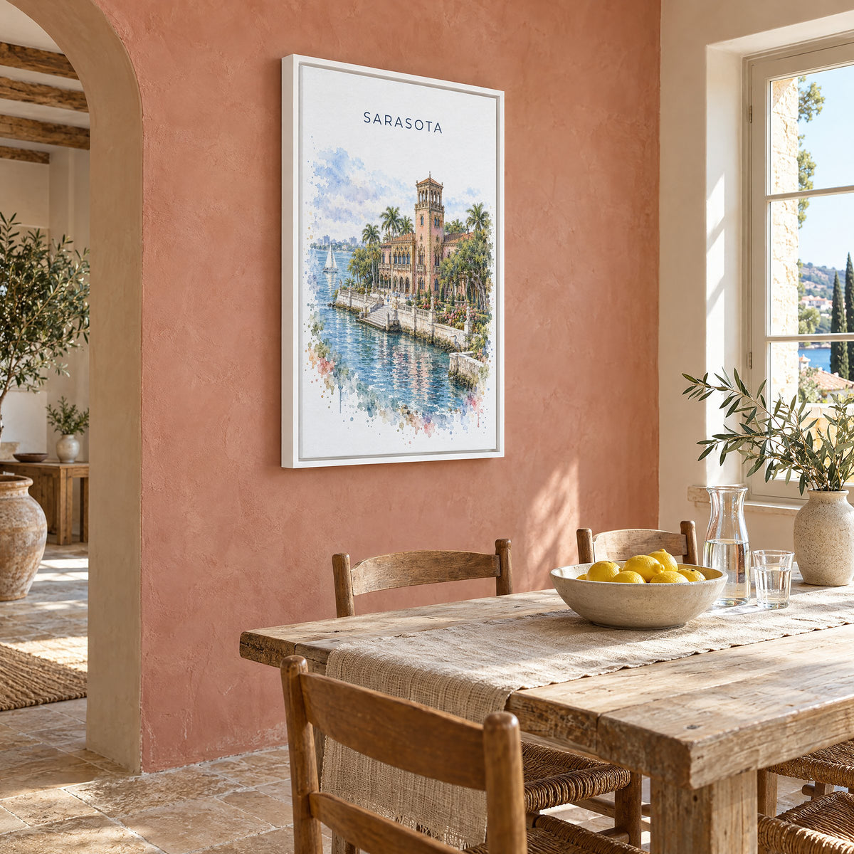 Sarasota watercolor print as a white floater canvas on a terracotta wall above a rustic dining table