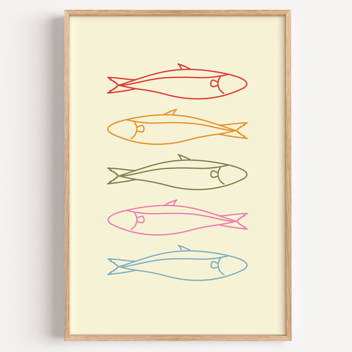 Pastel sardine row print in a light oak frame on a plain white wall