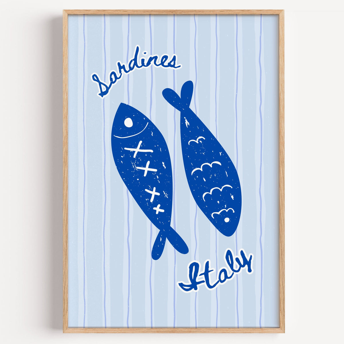 Sardines Italy blue fish print in a light oak frame on a plain white wall