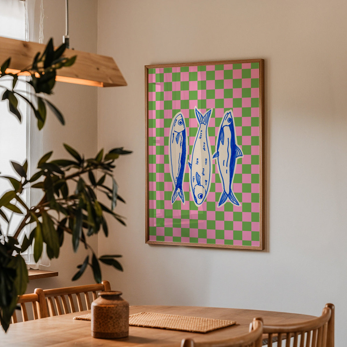 Sardines checkerboard print in a walnut frame above a dining table with olive branches