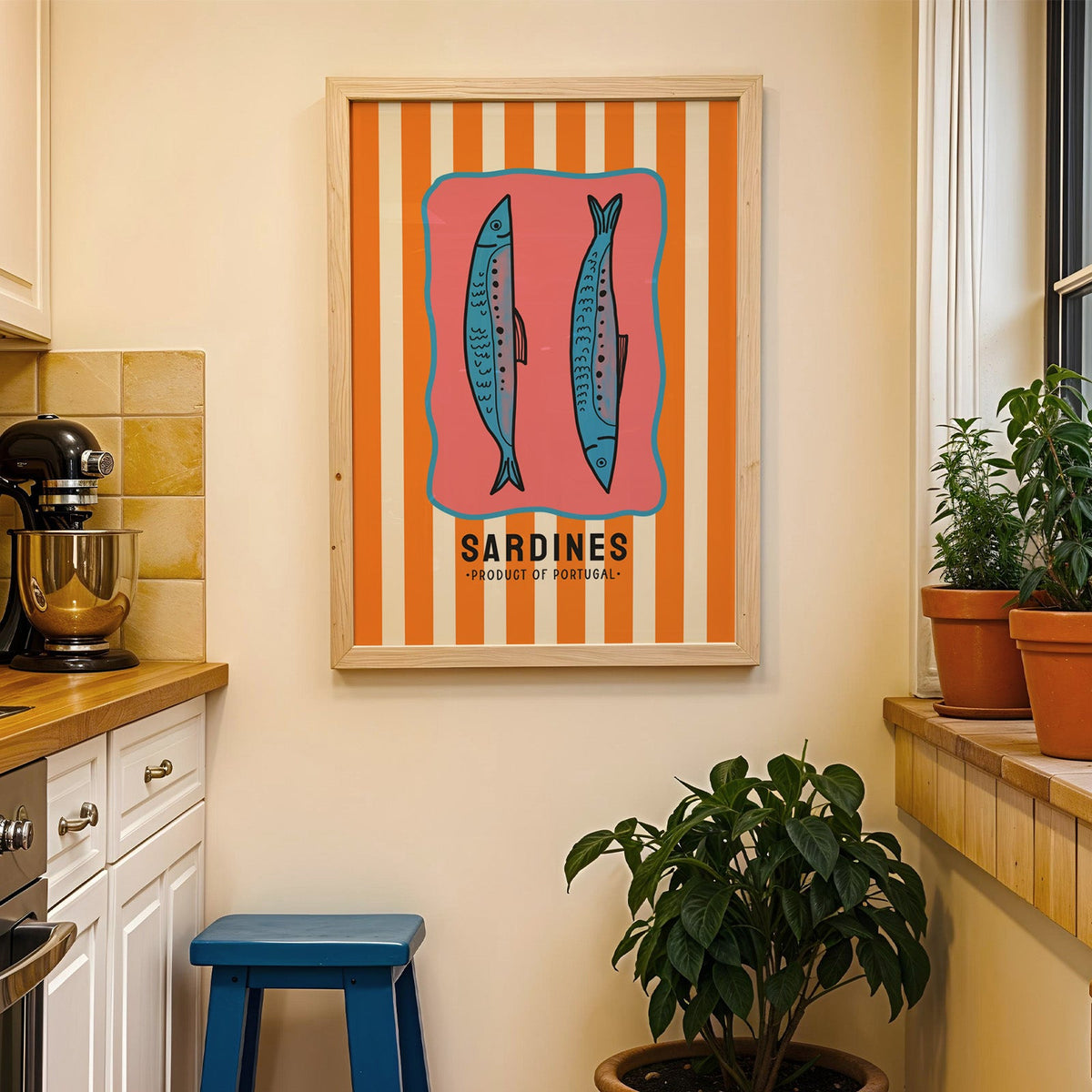 Sardines of Portugal print in a wood frame on a yellow tiled kitchen wall